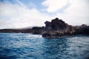 View from the water to the steep rocky coastline