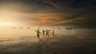 happy people on the beach at sunset