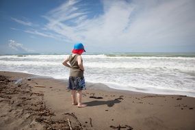 lonely kid thinking on the beach