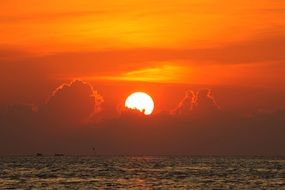 white sun on orange sunset background