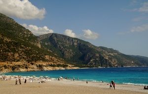 people on beach at mountain coast, turkey, marmaris
