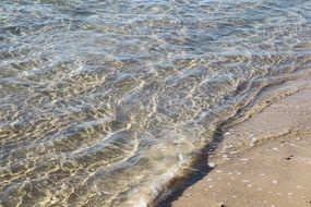 ocean waves washing sand