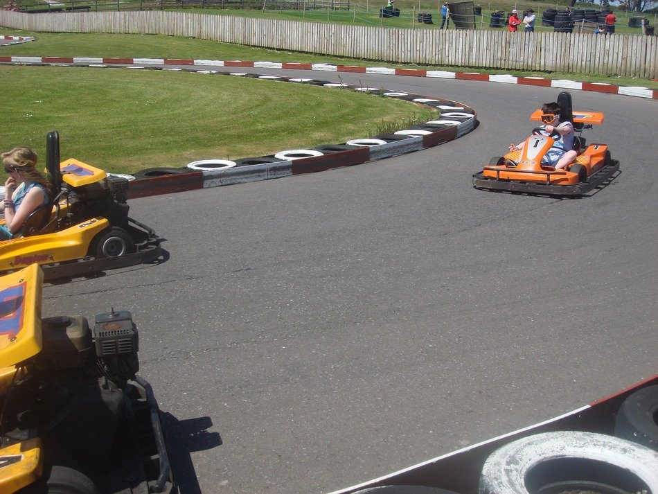 children on the colorful go-karts on the track