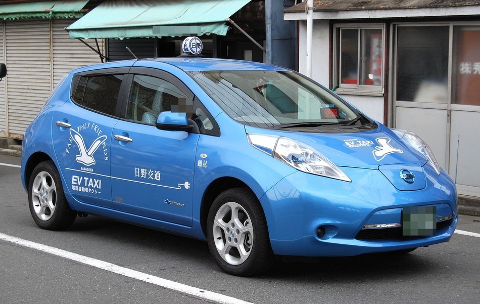blue Nissan on the road