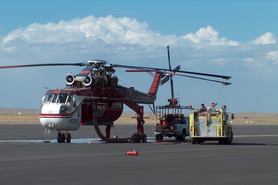 Helicopter and fire truck with the field on background