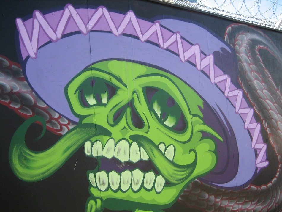 green skull with hat on the wall