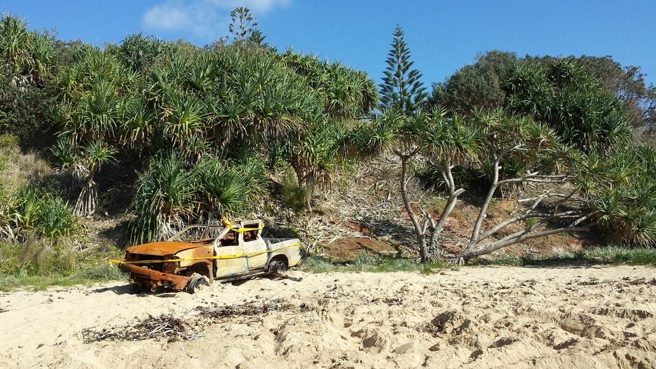 rusty car on the beach