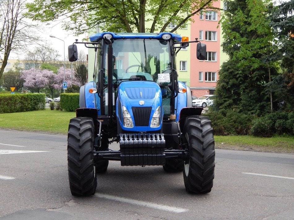 blue tractor on a city street