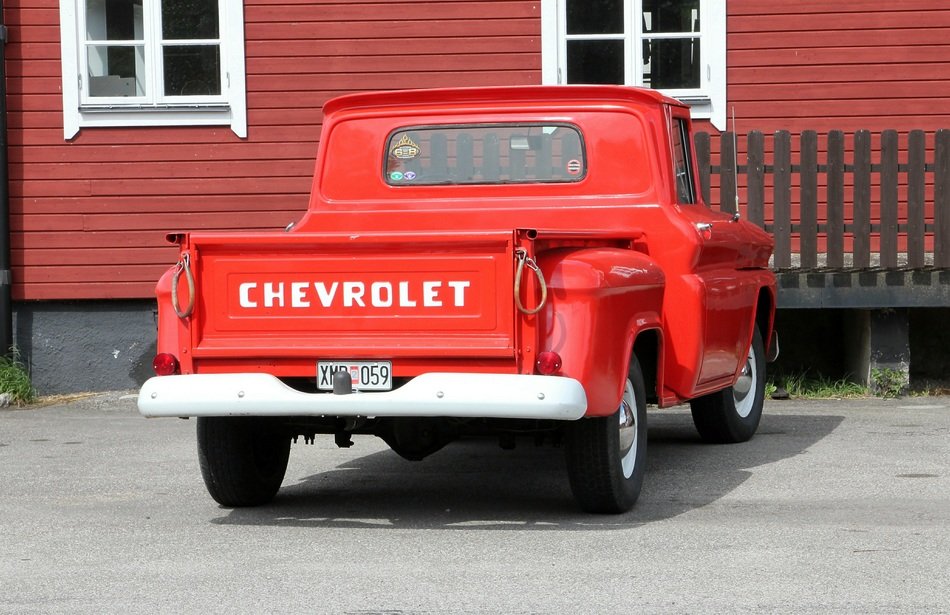 red pickup stands near the house