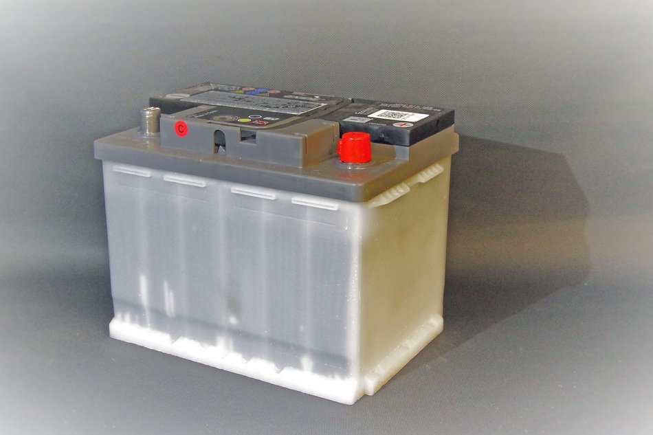 car battery near the gray wall