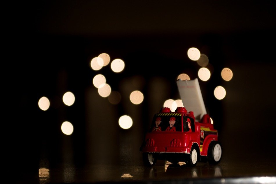 toy fire engine on christmas lights background