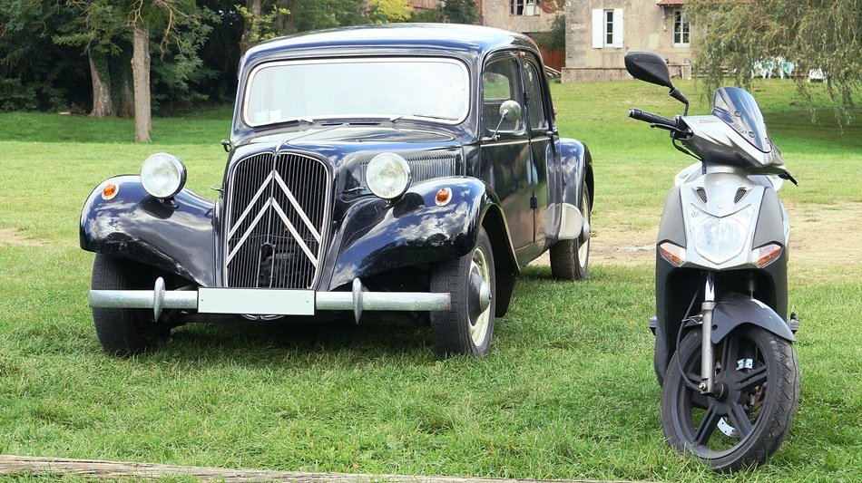 scooter near the black car