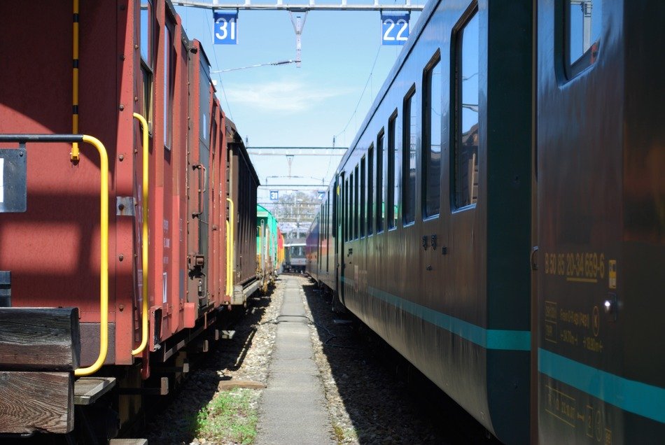 two electric trains stand at the station