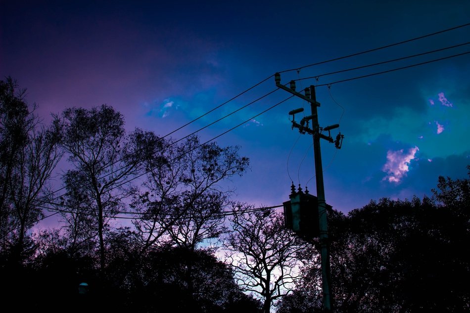power lines on a background of blue-violet sunset