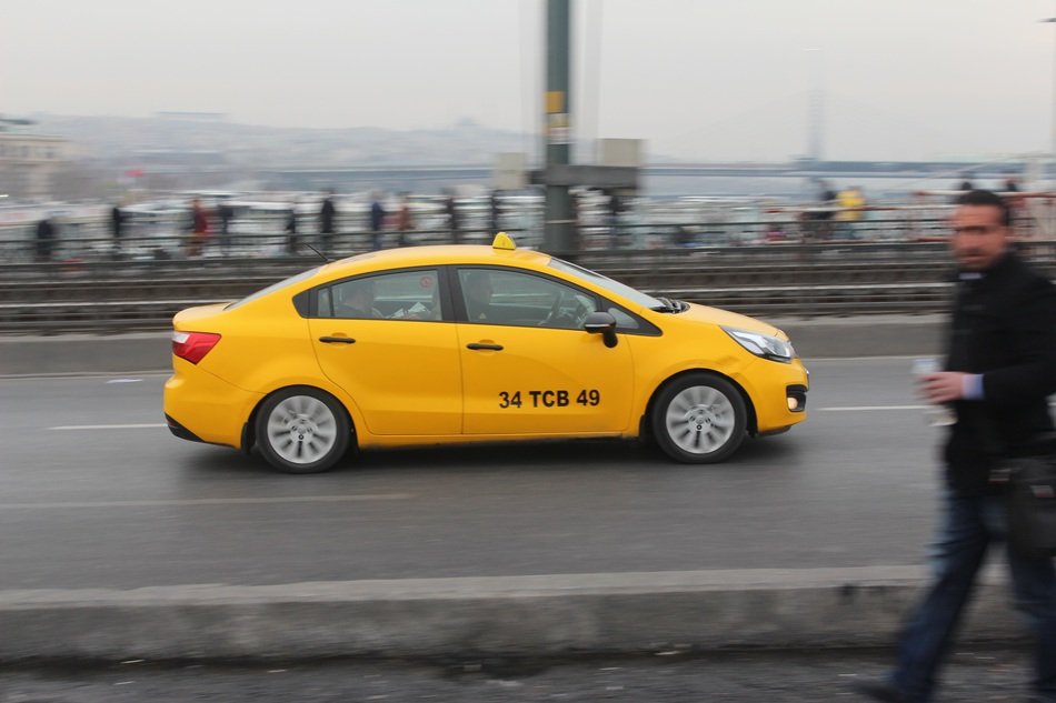 yellow taxi rushes along the promenade in Istanbul