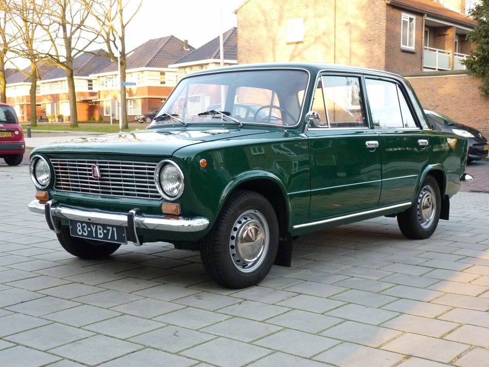 green old car on the road