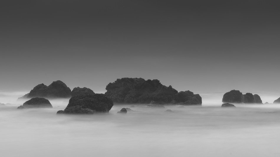 coastal stones in haze in black and white background