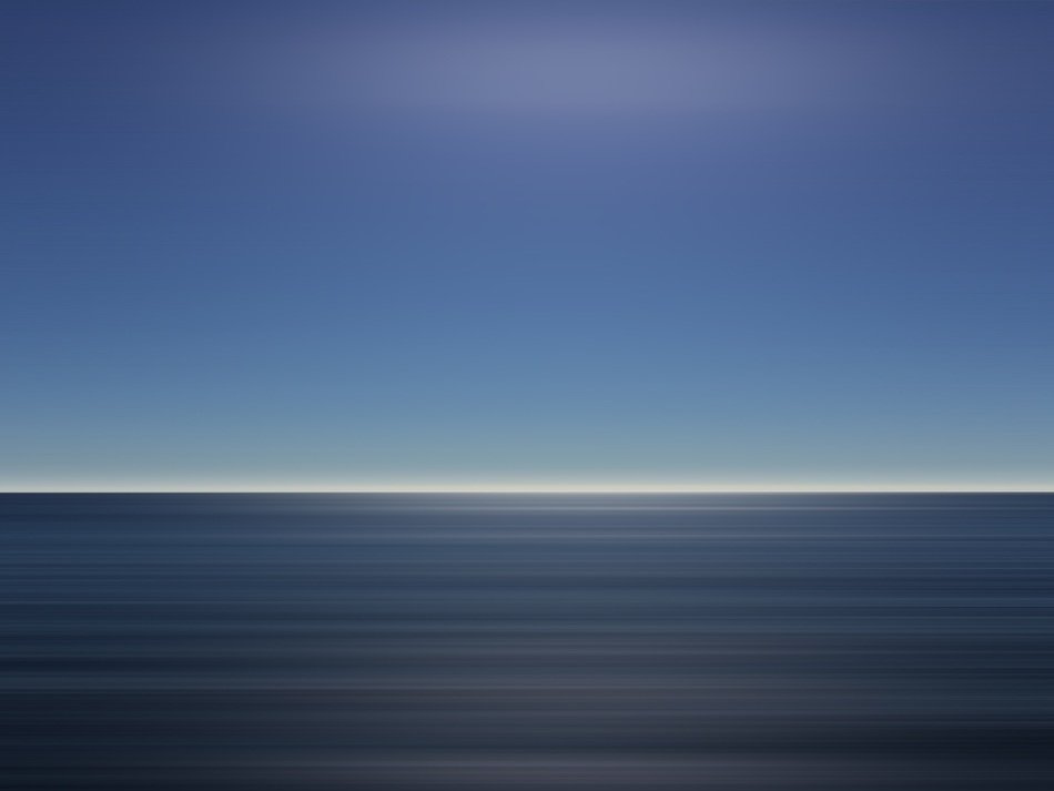 A quiet surface of the ocean with a horizon strip