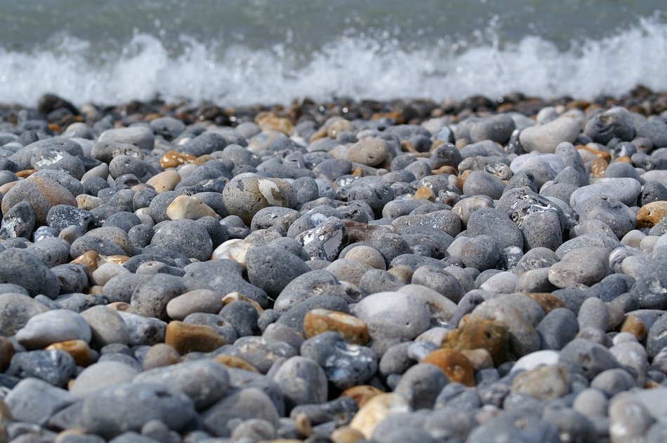Pebbly beach on the background of the surf
