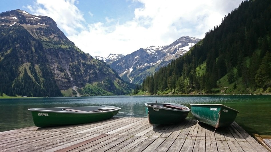 pier with boats on the lake in Alpine Tyrol