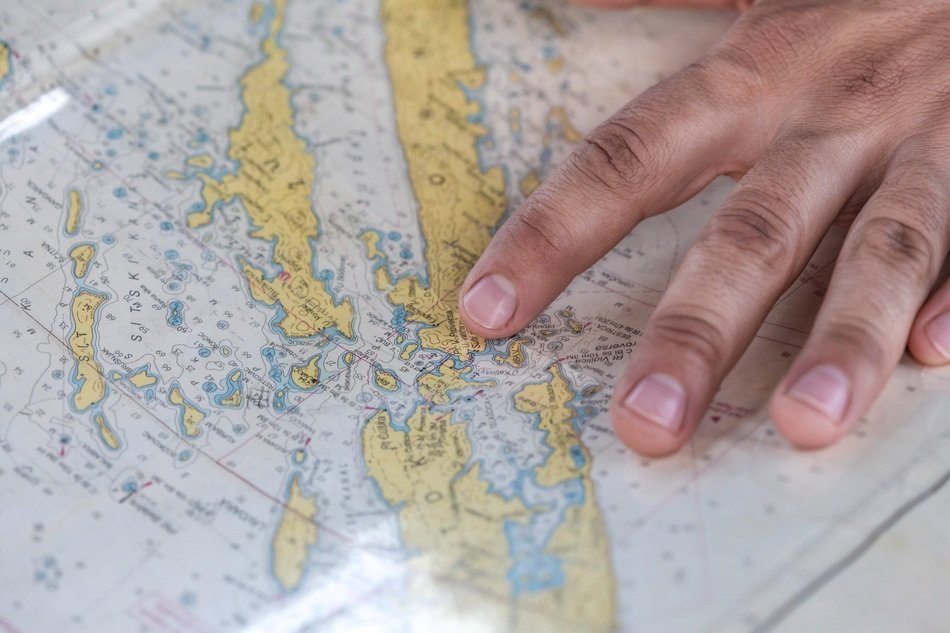 hand on sea map close up