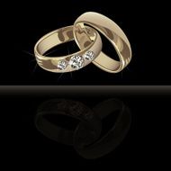 Wedding platinum rings with brilliants on the black background