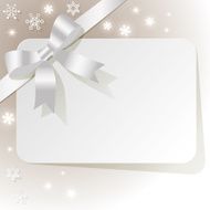 Gift Card with white ribbon on a beige background snowflakes