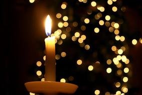 burning candle on a stand