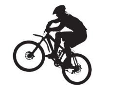 silhouette of a young man on a mountain bike