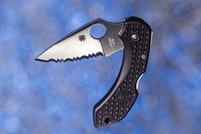 pocket knife on a blue blurred background