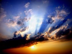The setting sun through the clouds