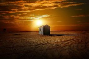 sunset lighting above the hut in the desert