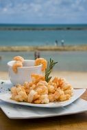 shrimp on plate beach view