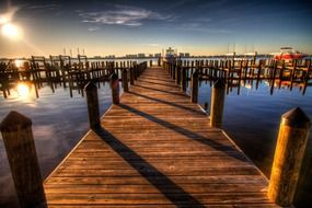 long wooden pier in the harbor at dusk