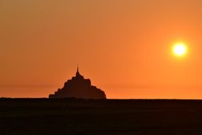 fortress on the island of Mont Saint-Michel on the background of a golden sunset