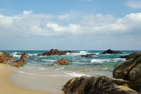Landscape of rocks on a sand beach
