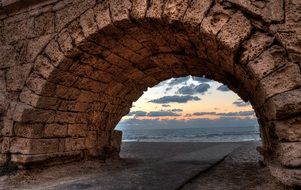 sunset view through a brick arch