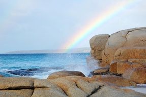 rainbow over the rocky coast of australia