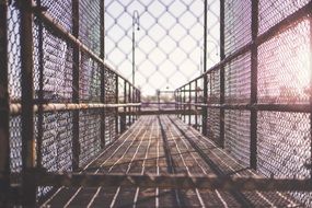 walkway planks metal fence urban sunset