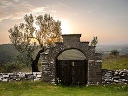 landscape of stone fence with gates at sunrise