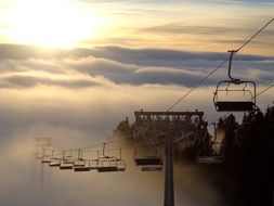 ski lift in fog at sunset, slovenija, krvavec