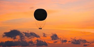 silhouette of a balloon with a basket at sunset