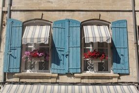 blue wooden shutters on the windows of a house in France