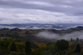 late summer hills in the clouds