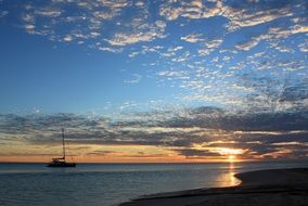 boat on the tropical beach at sunset