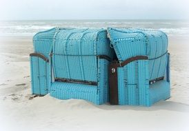 blue beach chairs on a white sand beach