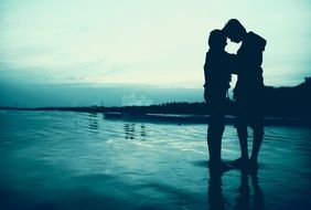 silhouette of a romantic couple in the water