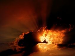 Rays of the sun at sunset through the clouds