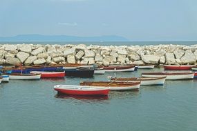 fishing boats moored at the stone fence