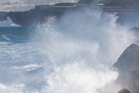 waves splashing on rocks an coast